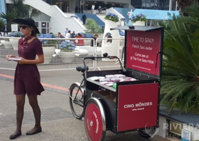 Hôtesse et vélo triporteur pour Cinq Mondes - Riviera Pub - Street Marketing Nice, Cannes, Monaco